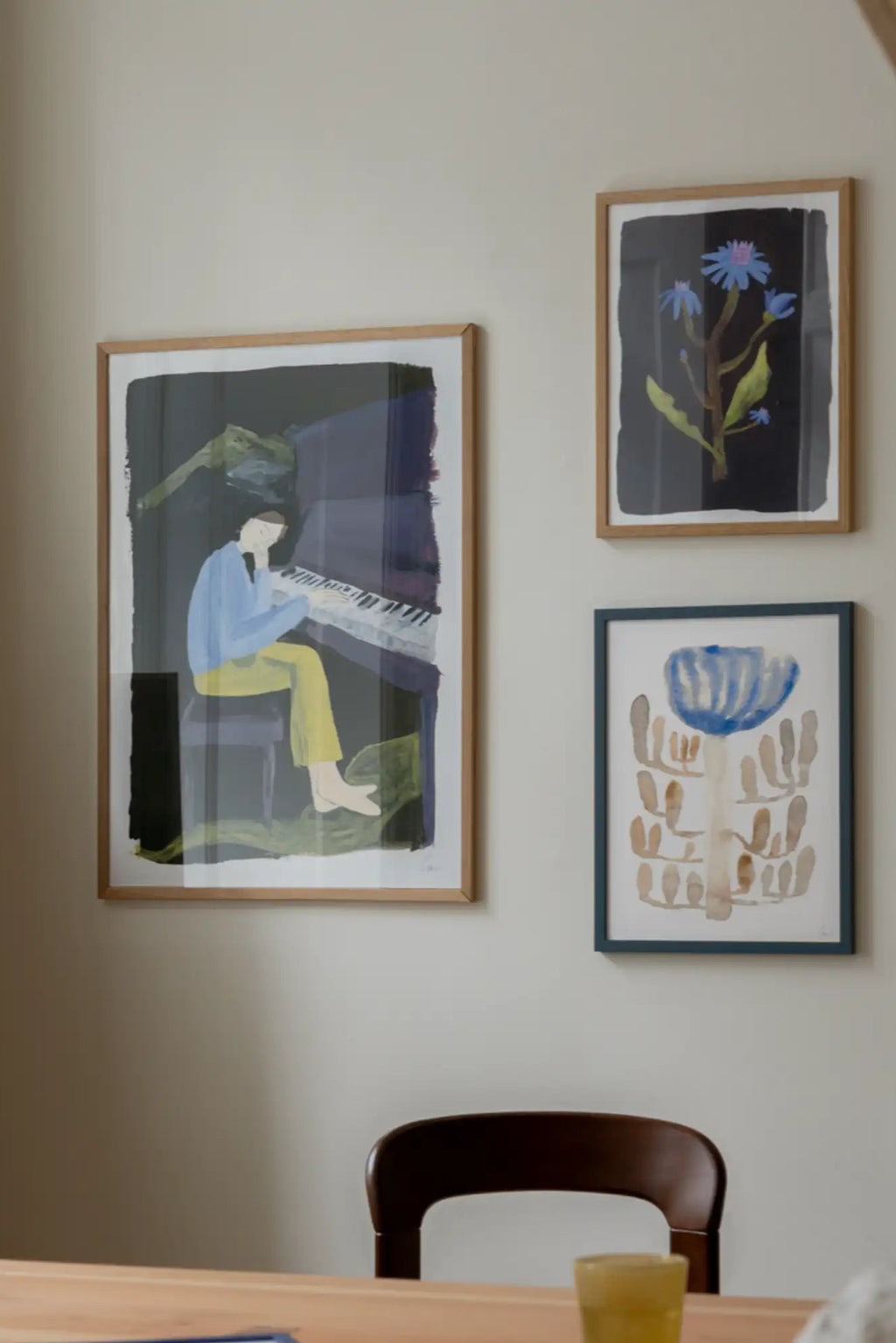 The Poster Club Hania at the Piano, a contemporary abstract art print depicting a figure playing a piano with expressive, painterly brushstrokes in muted blues and yellows against a deep, dark grey and.