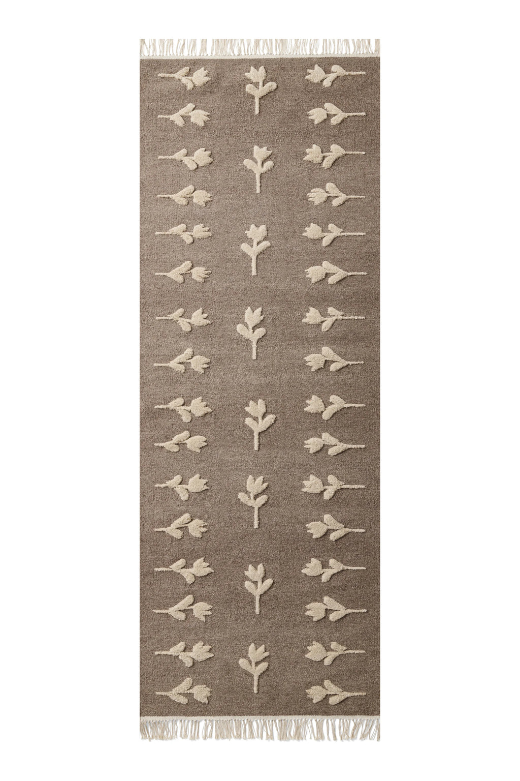 Cappelen Dimyr Colonnade No.09 Rug, a hand-knotted wool runner rug featuring a warm brown flat-woven base with a raised, textured cream tufted floral pattern and delicate fringed ends. This organic modern and Scandinavian-inspired rug is perfect for adding soft texture to hallways, bedrooms, or entryways.