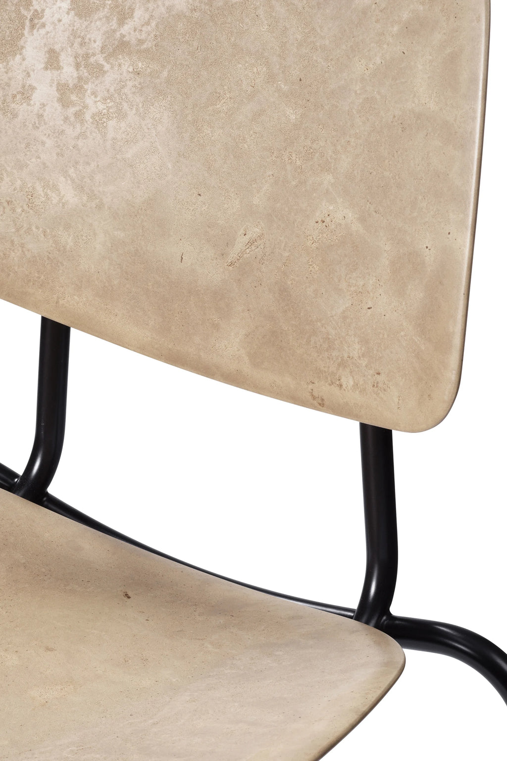 Close-up of the Mater Compound Dining Chair's light brown textured seat and backrest, emphasizing the unique material and subtle pattern. The sleek black metal frame is visible, highlighting the chair's premium craftsmanship.