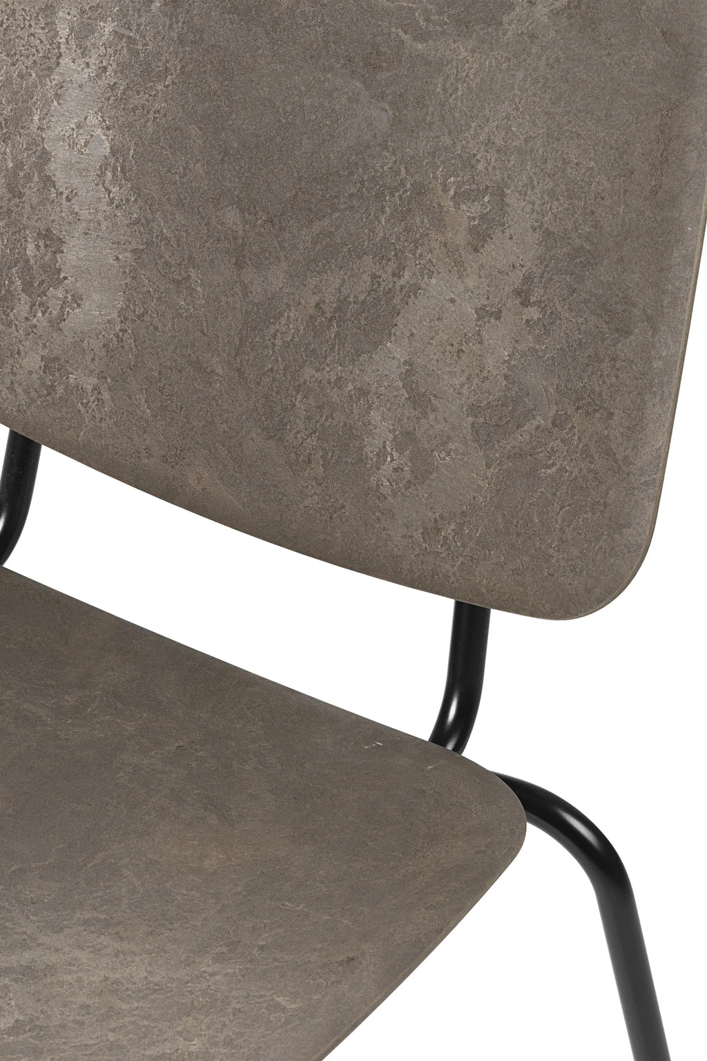 Mater Compound Lounge Chair, close-up detail of the dark grey, textured seat and backrest, revealing the unique material pattern and the connection to the black metal frame, on a white background.