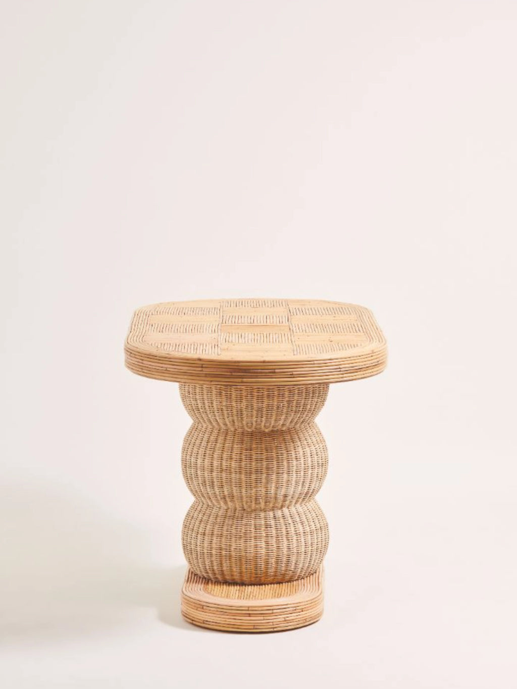 Heaps & Woods Barney Console, an organic modern console table crafted from natural woven rattan in warm beige tones, featuring a distinctive stacked hourglass base and a rectangular top with a flat patterned surface and ribbed edges.