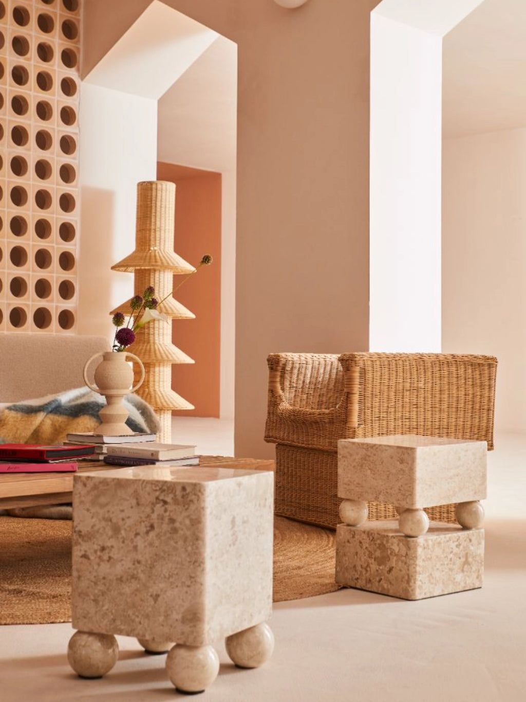 Heaps & Woods Conor Side Table, a unique organic modern side table crafted from natural beige travertine with a textured finish, featuring a cubic top and base separated by four spherical travertine elements. This contemporary stone accent table, with its minimalist brutalist aesthetic, is ideal for living room decor, a stylish bedroom bedside table, or as a striking entryway piece.