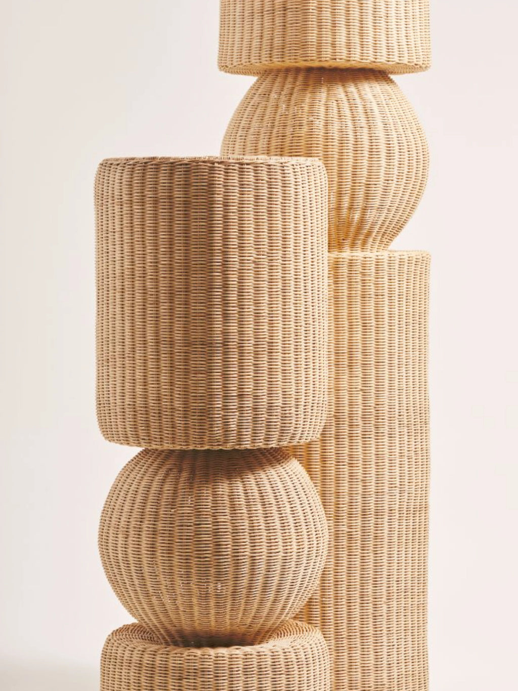 Heaps & Woods Luz Standing Lamp, a natural light tan woven rattan floor lamp featuring a unique stacked geometric design of cylinders and spheres with a textured, ribbed surface. This organic modern standing lamp brings a warm, coastal, or boho aesthetic to living rooms, bedrooms, or cozy reading nooks.