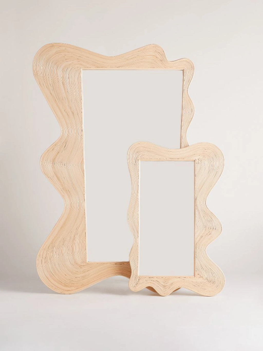 Heaps & Woods Zoe Mirror, an organic modern mirror with a distinctive wavy, squiggly frame crafted from layered natural rattan in a light, neutral tone.