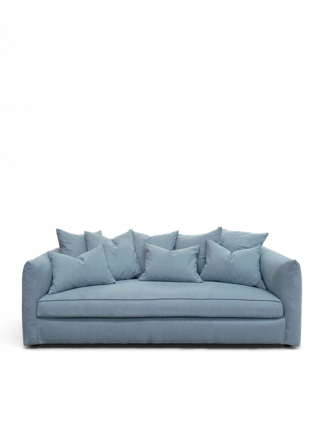 Tinted Objects Cornell Sofa, a modern light blue fabric sofa with plush cushions and clean piping details. This stylish and comfortable couch is ideal for contemporary living rooms and cozy family spaces.