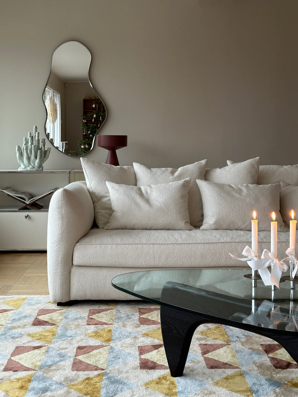Tinted Objects Cornell Sofa, a luxurious off-white boucle fabric couch with plush cushions, perfectly styled in a contemporary living room. This elegant sofa offers comfortable seating for modern home decor enthusiasts.