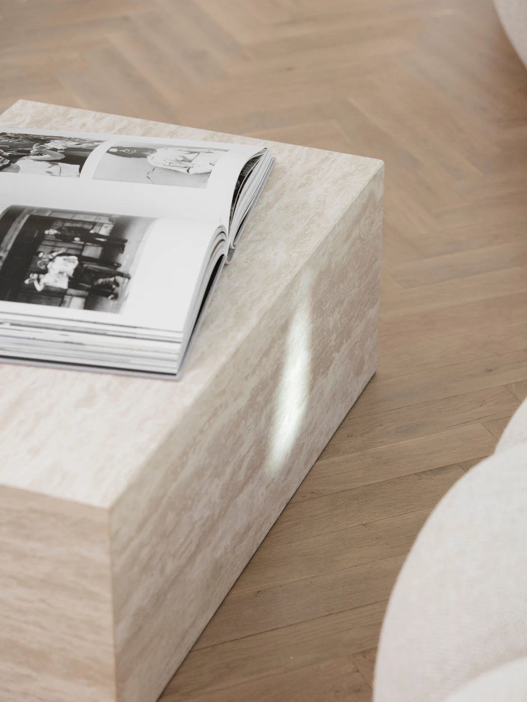 NORR11 Cubism Coffee Table, a modern minimalist coffee table crafted from light beige travertine stone, featuring a solid rectangular block silhouette with natural veining and a porous texture. This organic modern plinth table is perfect for contemporary living rooms, brutalist-inspired lounge areas, or as a sophisticated side table.