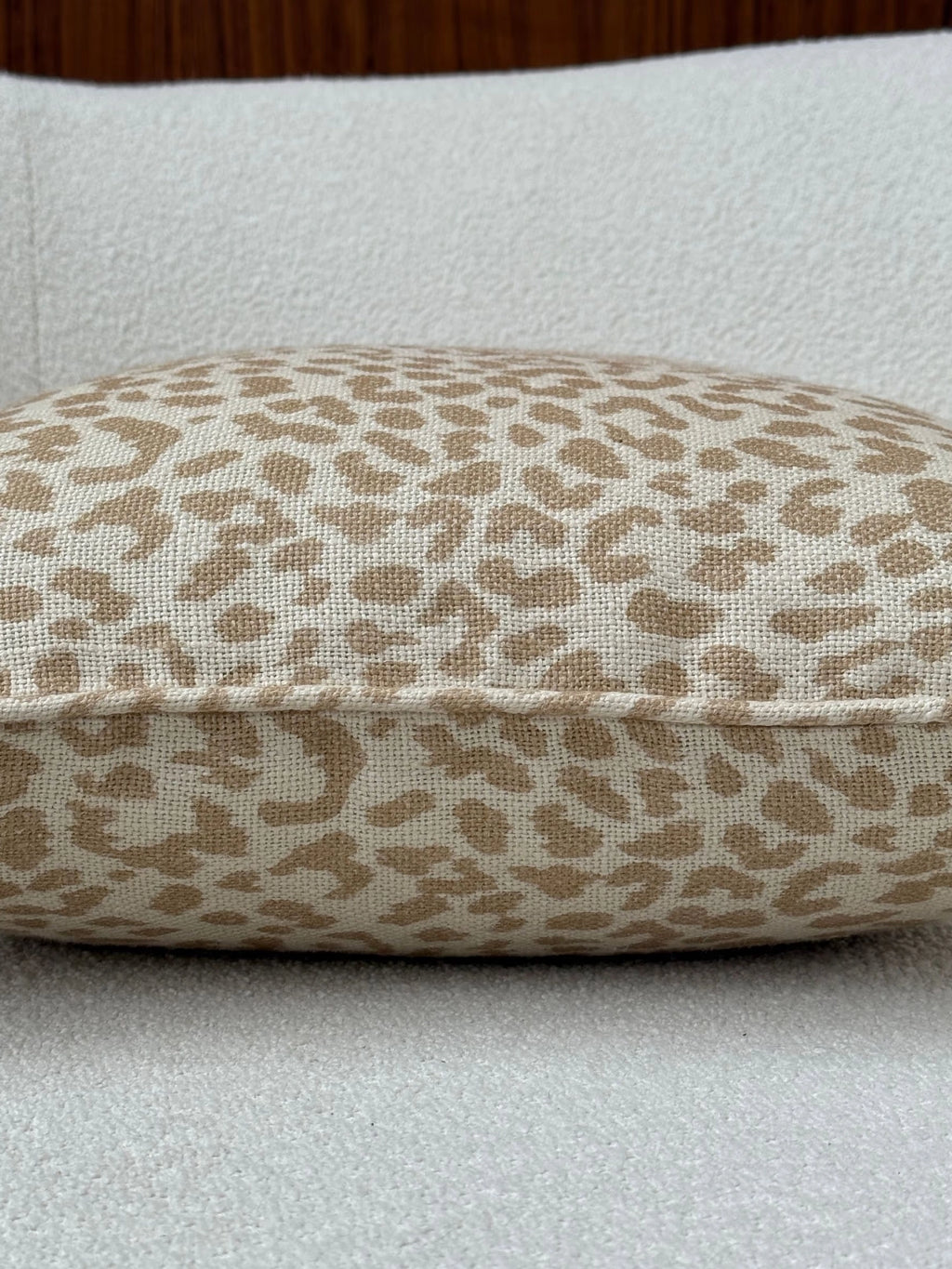 Tinted Objects Norell Throw Pillow, a stylish rectangular cushion with a natural beige and tan leopard print pattern on textured woven fabric. This chic accent pillow is perfect for adding a touch of modern flair to sofas, chairs, or beds in a contemporary home.