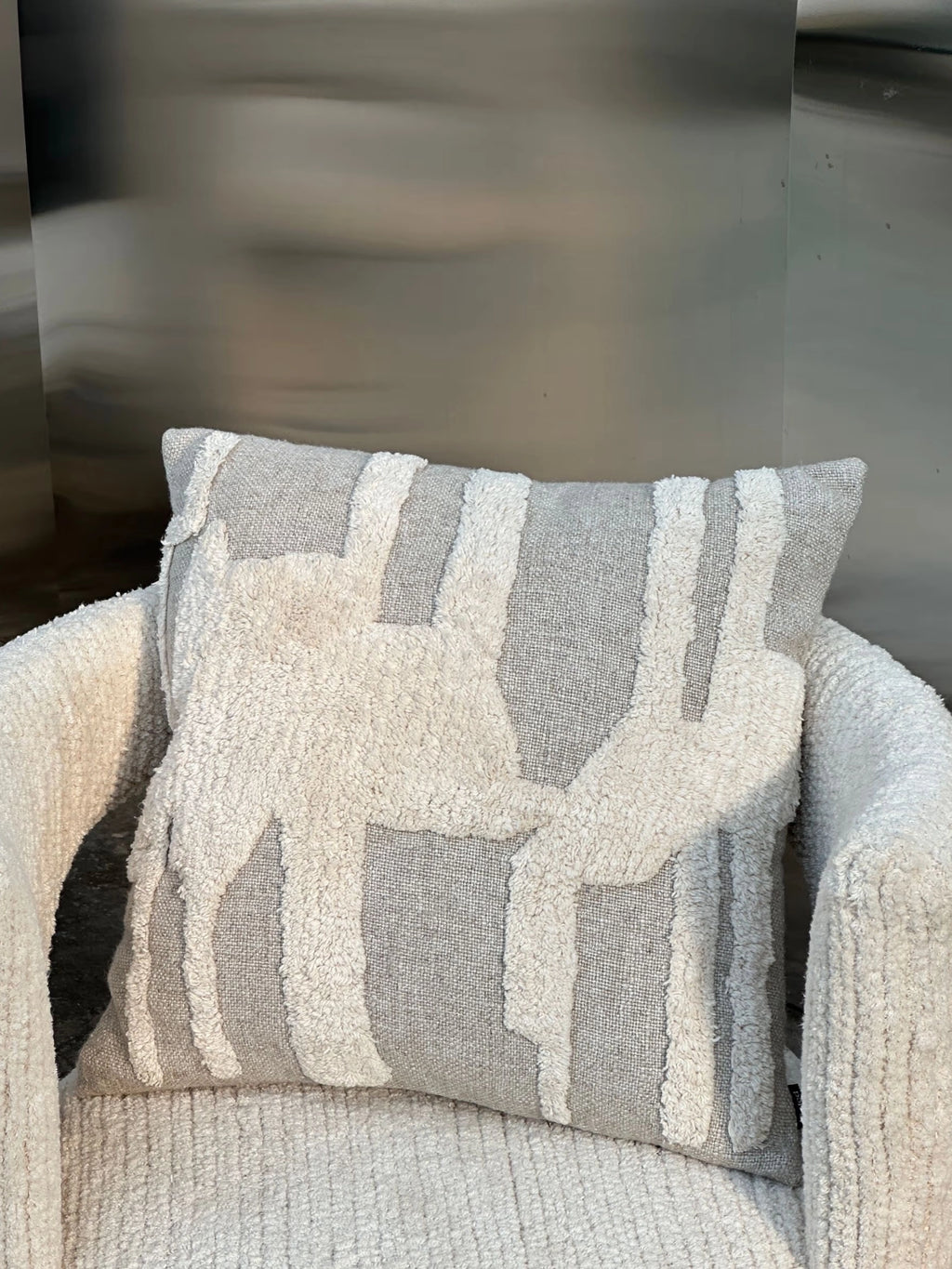 Tinted Objects Eksand Throw Pillow, featuring a modern abstract design with plush cream-colored tufting on a light grey woven fabric. This stylish decorative cushion adds texture and comfort to any living space, perfect for contemporary home decor enthusiasts.