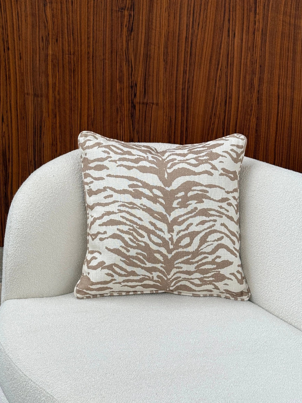 Tinted Objects Norell Throw Pillow, a modern square throw pillow featuring a striking neutral animal print design. It showcases an off-white textured woven fabric base with abstract beige and tan tiger stripe patterns. This contemporary decorative cushion is perfect for adding an organic modern accent to living room sofas or bedroom decor.