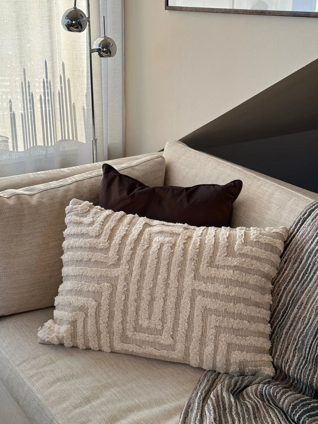 Tinted Objects Telin Throw Pillow, a rectangular beige woven cushion with a textured, raised geometric maze pattern. This modern, stylish accent pillow is perfect for adding comfort and decorative flair to sofas or beds in contemporary living spaces.