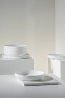 White ceramic bowls on a neutral background