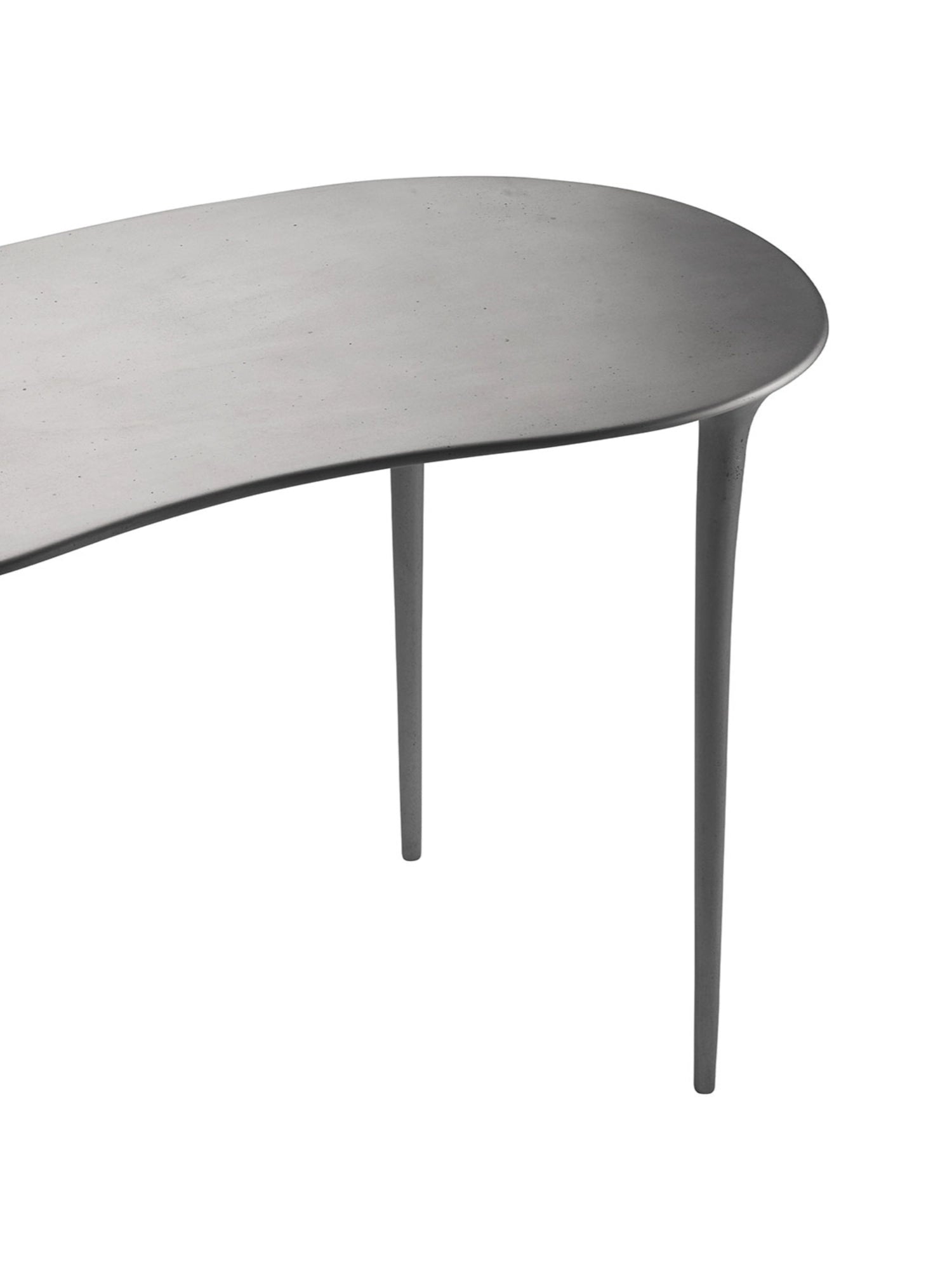 Tine K Dune Recycled Aluminium Desk, a contemporary organic modern desk featuring a curved, kidney-bean shaped tabletop and slender tapered legs, all crafted from matte dark grey recycled aluminium with a.
