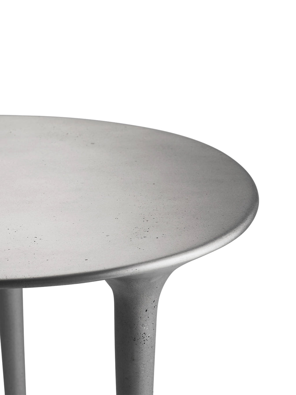 Tine K Dune Recycled Aluminium Desk, a round industrial chic desk in a matte light grey finish, featuring a sculptural base and a textured concrete-look surface. This organic modern desk is crafted from sustainable recycled aluminium, perfect for a minimalist home office or contemporary living space.