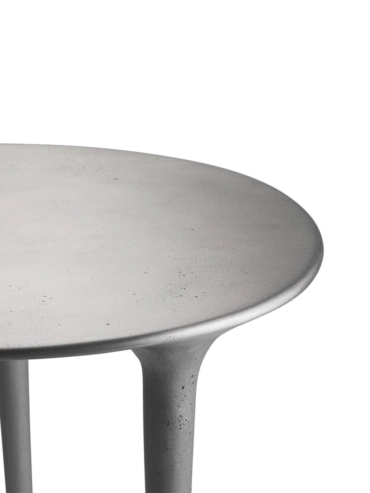 Tine K Dune Recycled Aluminium Desk, a round industrial chic desk in a matte light grey finish, featuring a sculptural base and a textured concrete-look surface. This organic modern desk is crafted from sustainable recycled aluminium, perfect for a minimalist home office or contemporary living space.