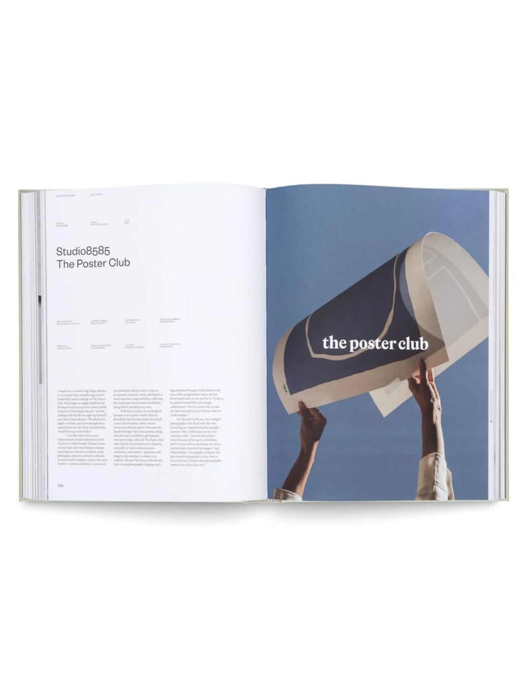 Book Designing Brands, an open hardcover book displaying a clean white page on the left with black text and the title "Studio8585 The Poster Club," contrasting with a vivid blue page on the right featuring hands holding a curved poster with "the poster club" text. This essential branding and graphic design book is perfect for students, designers, and marketing professionals seeking creative inspiration.