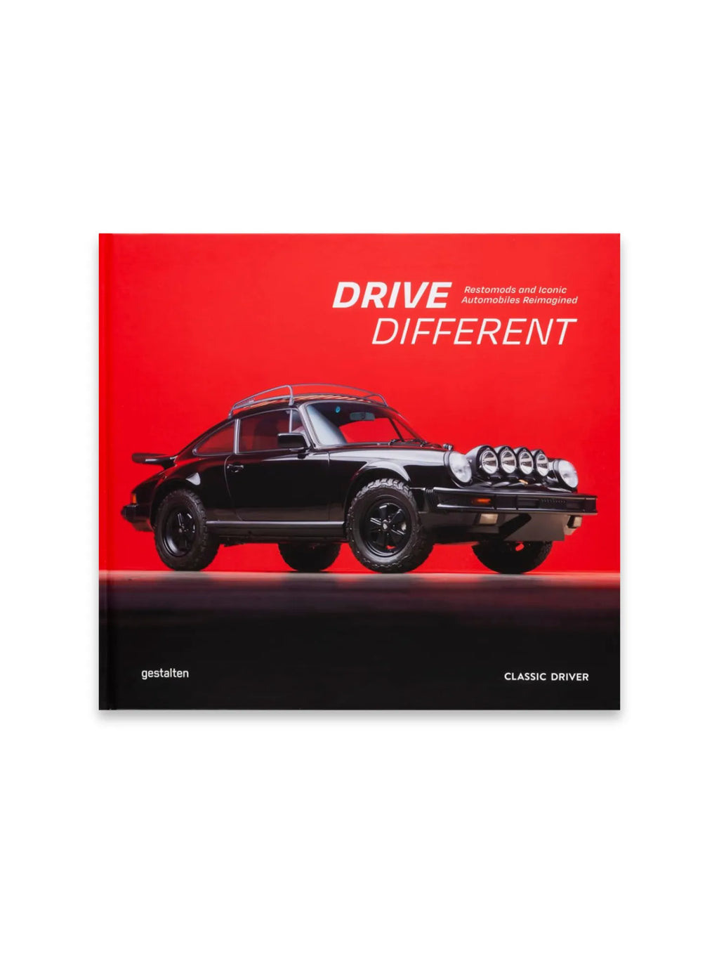 Book Drive Different, a striking red and black book cover featuring a classic black Porsche 911 restomod with rally lights and a roof rack. This premium automotive book is perfect for car enthusiasts and collectors interested in iconic reimagined automobiles.