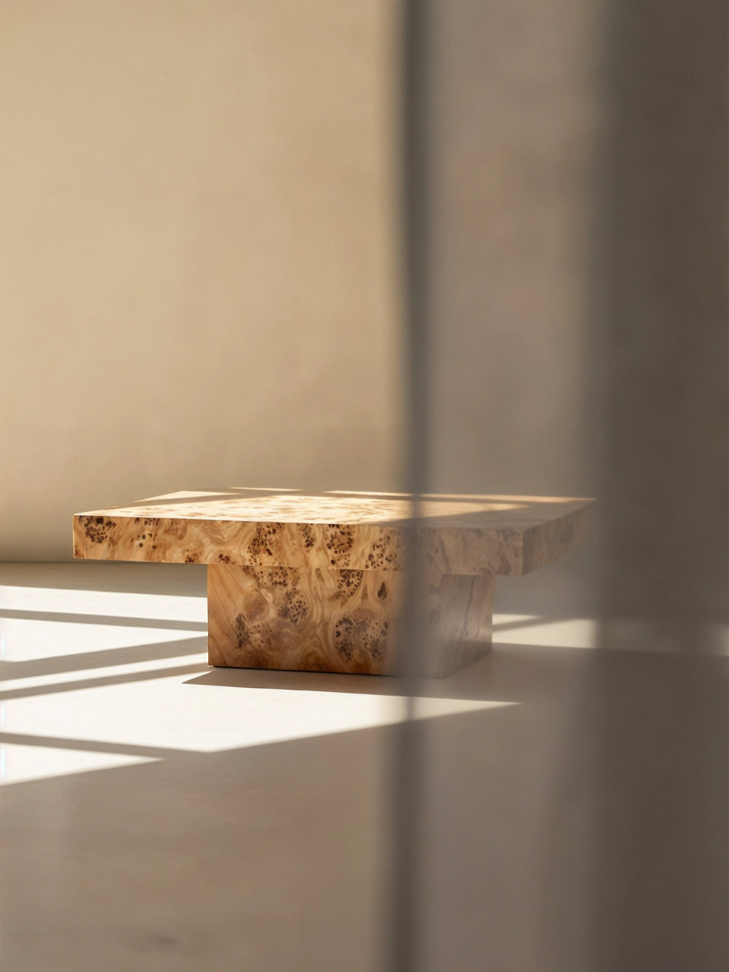 TCL Studios Dune Burlwood Coffee Table, a stunning organic modern low-profile coffee table crafted from solid burlwood with rich, warm natural wood tones and a unique intricate grain pattern. Its rectangular top rests on a substantial block base, embodying a minimalist yet bold design. Perfect as a contemporary living room centerpiece or for a sophisticated brutalist or japandi interior.