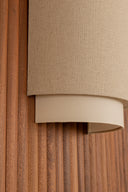 Close-up of a textured beige lampshade on a wooden surface