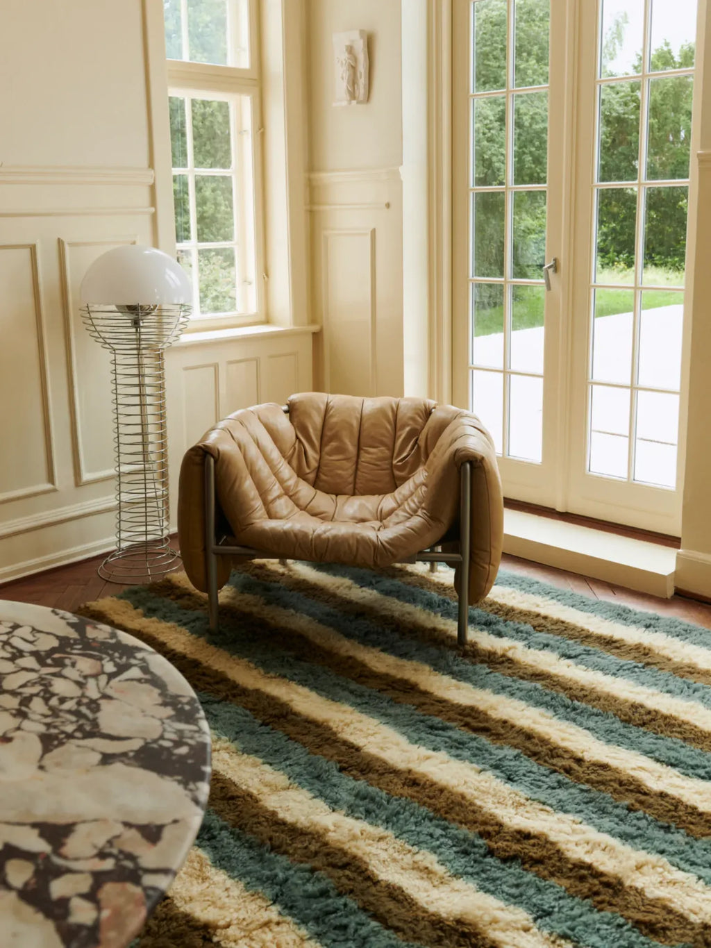 Layered Arable Land Shaggy Rug, a textured green, brown, and cream striped area rug with a plush pile. Perfect for adding warmth and vintage style to living rooms or bedrooms.