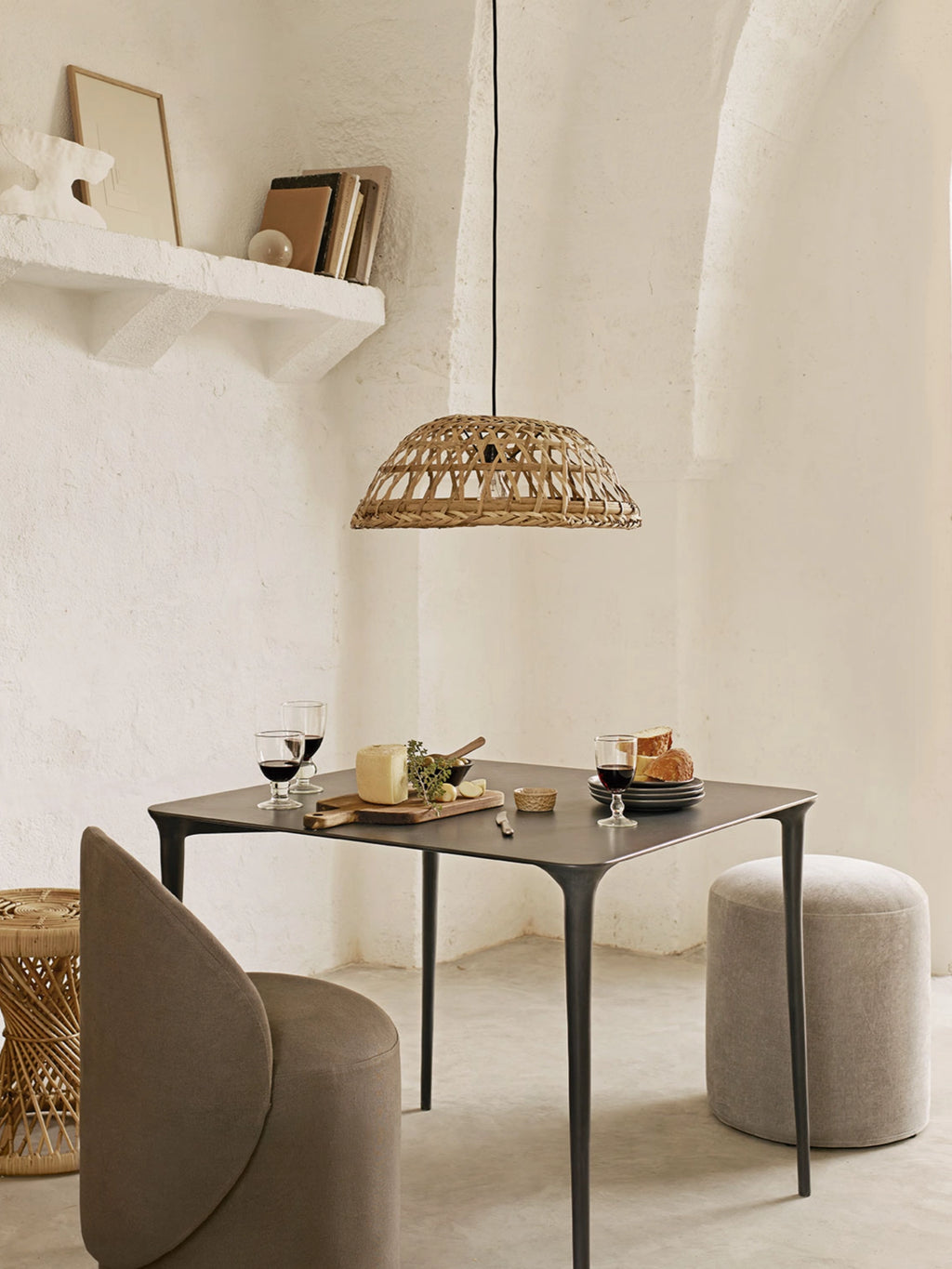 Tine K Metal Dining Table, a sleek matte dark grey metal dining table with a square top and gently rounded corners. It features elegantly tapered, sculptural legs, embodying a modern minimalist and organic contemporary design. Ideal for a chic dining room, kitchen, or small apartment living space.