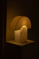 Mushroom-shaped lamp with a warm glow on a dark background