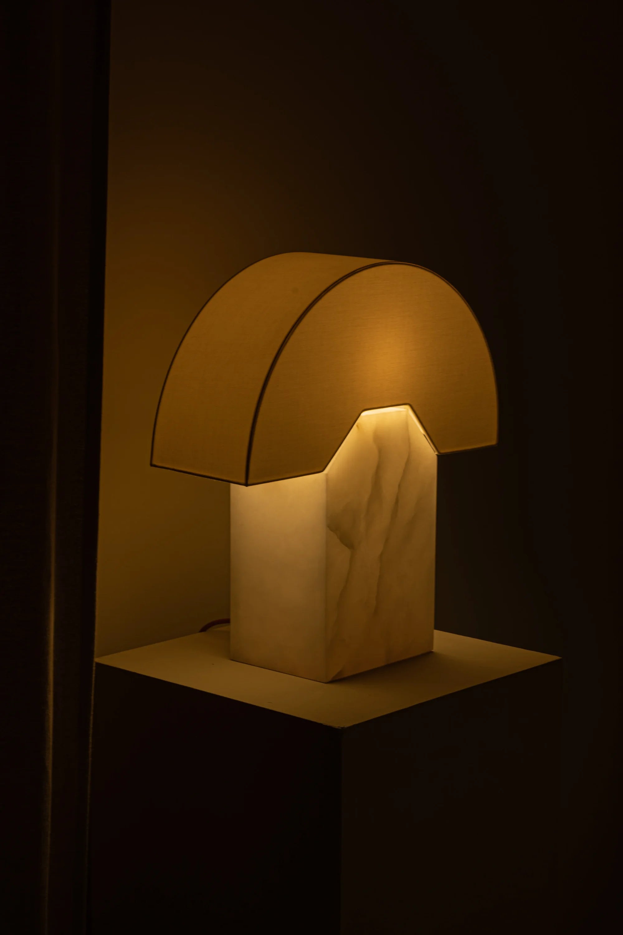 Mushroom-shaped lamp with a warm glow on a dark background