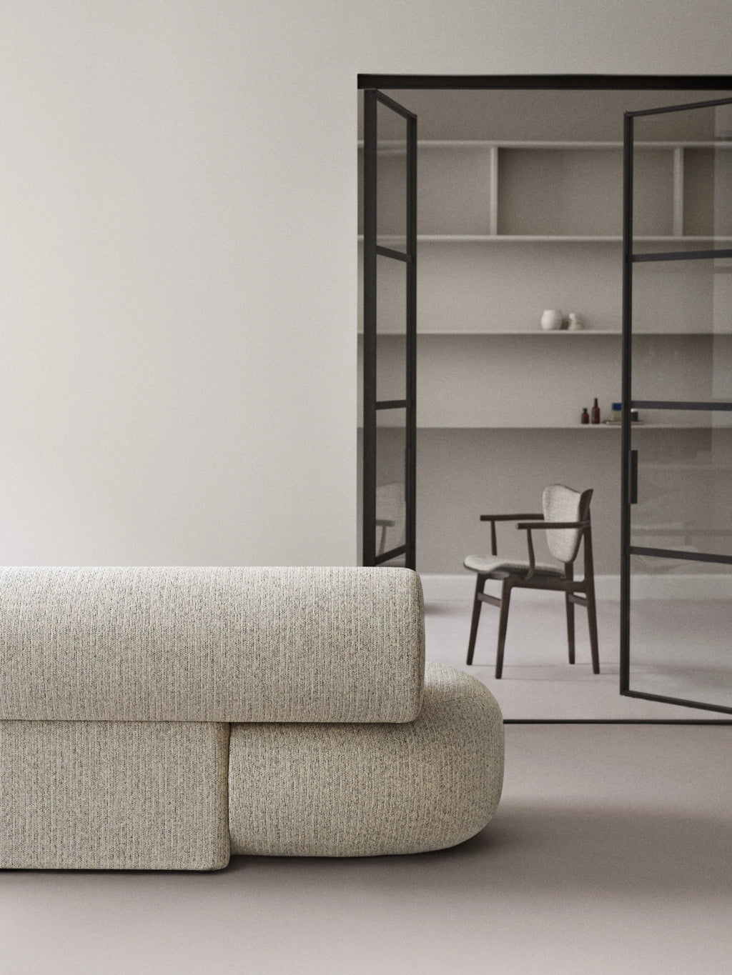 NORR11 Elephant Armchair, a premium, elegant armchair featuring soft, rounded forms upholstered in a textured, neutral-toned fabric. Its modern design provides a comfortable and stylish seating option for sophisticated interior spaces. This durable armchair is perfect for discerning individuals seeking luxury and comfort in their home or office.