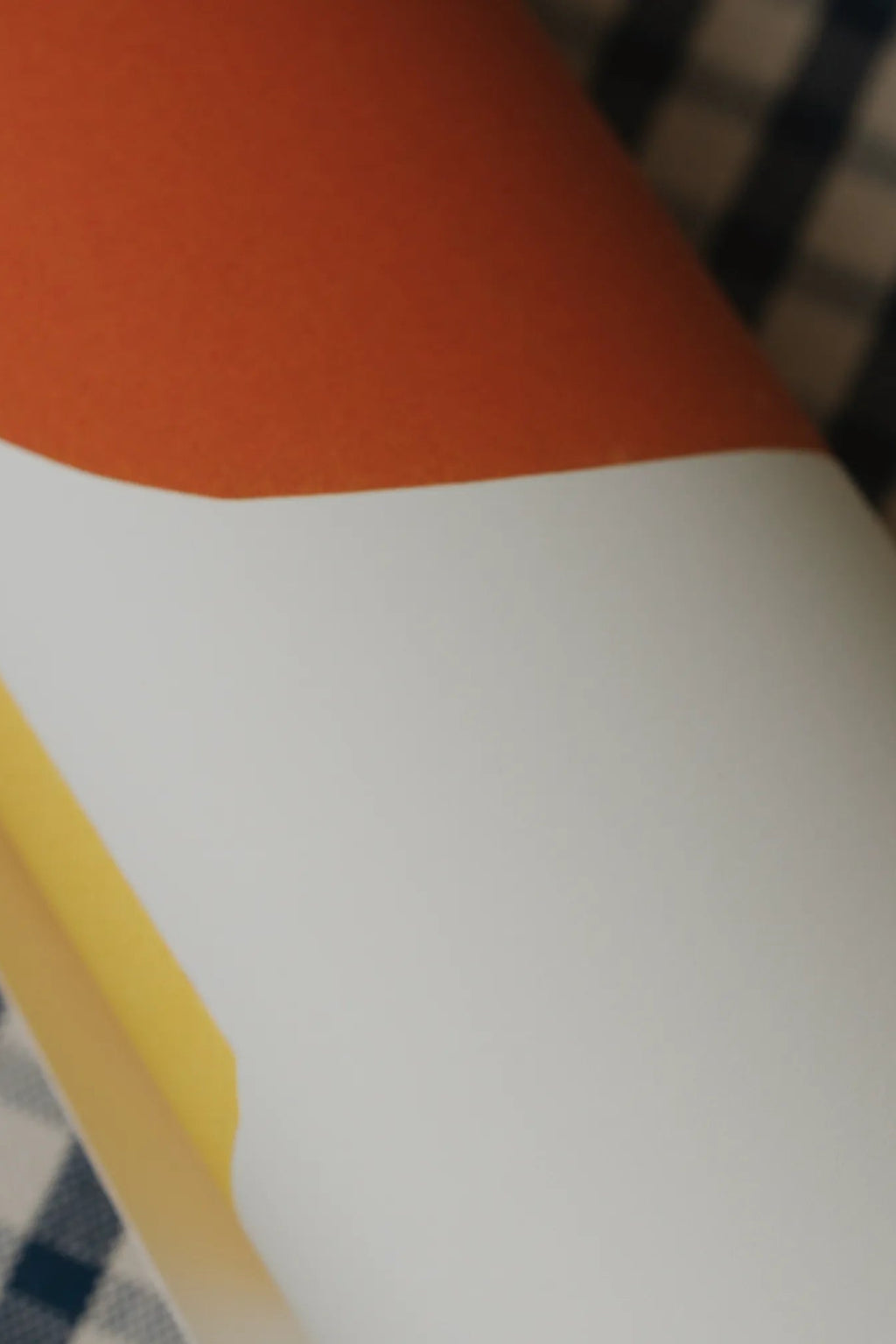 The Poster Club Balancing Act, a modern minimalist abstract poster featuring a bold color-block design with a warm terracotta orange top section, a clean white lower section, and a vibrant yellow stripe along the left edge.