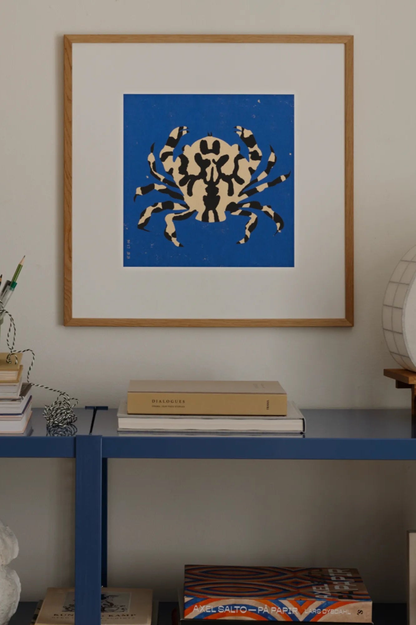 Calico Crab standing on rock near the ocean with waves crashing