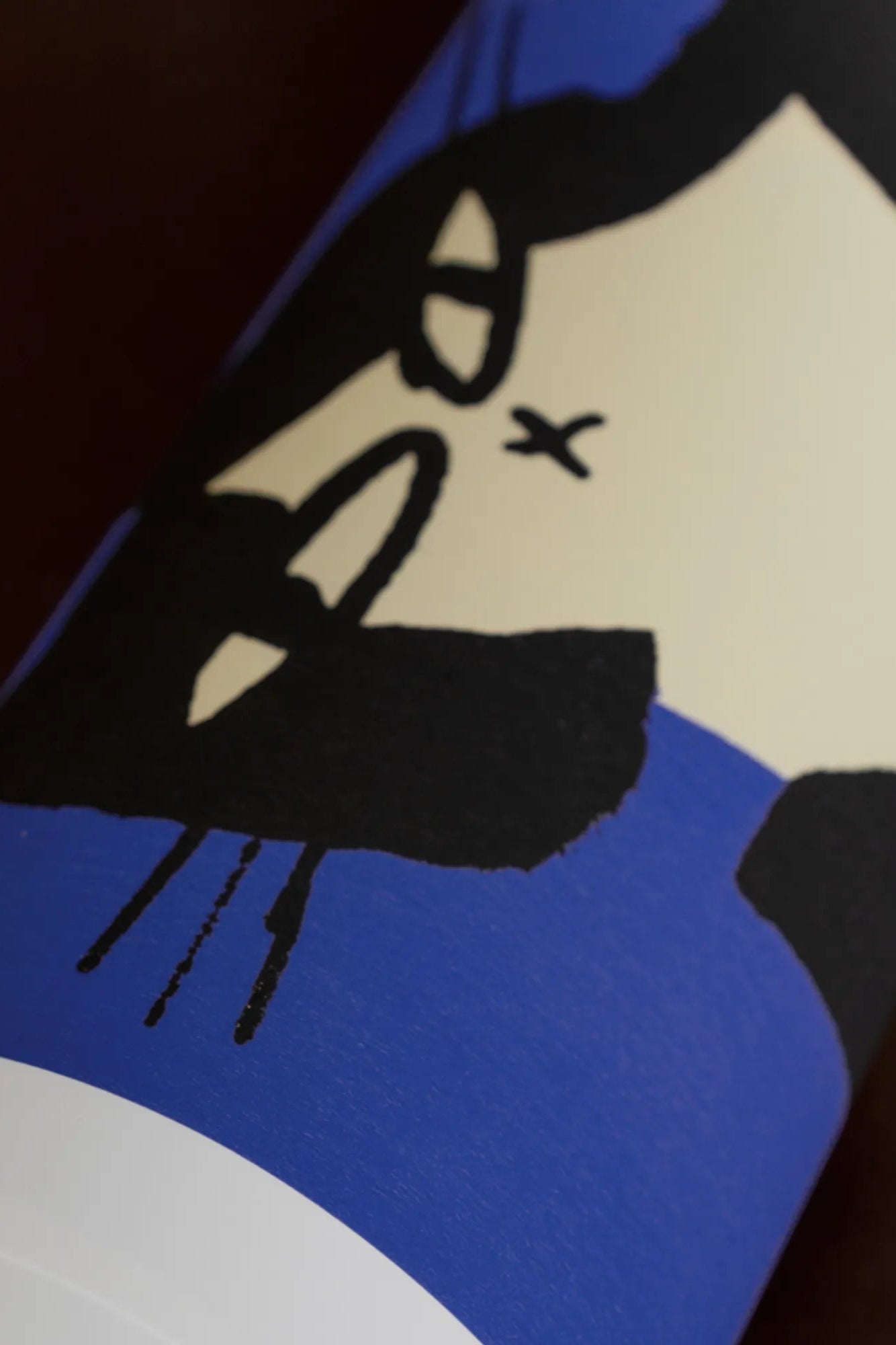 Beautiful fluffy gray and white cat sitting on a blue cushion