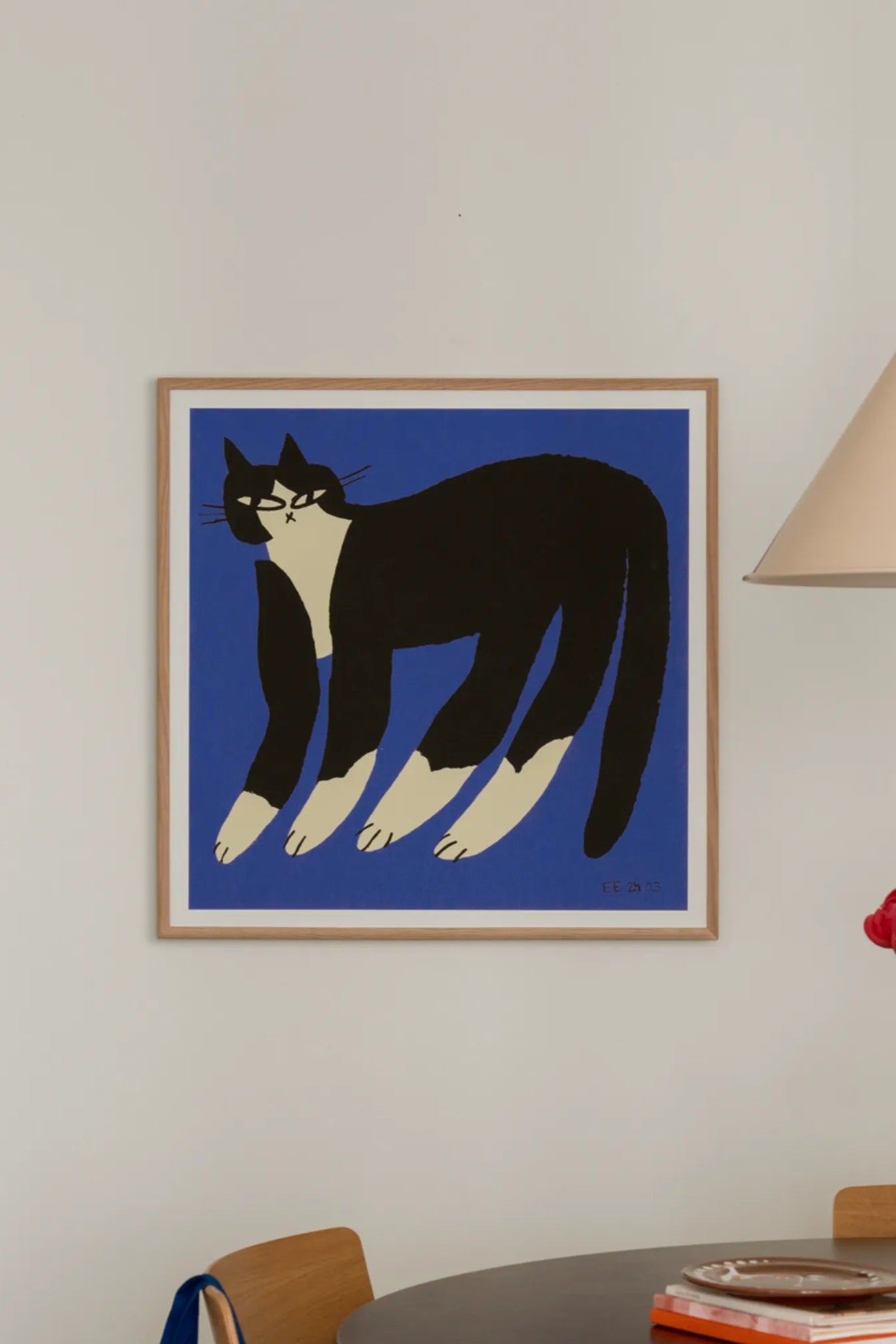 Adorable grey and white cat comfortably lounging on a soft blue cushion