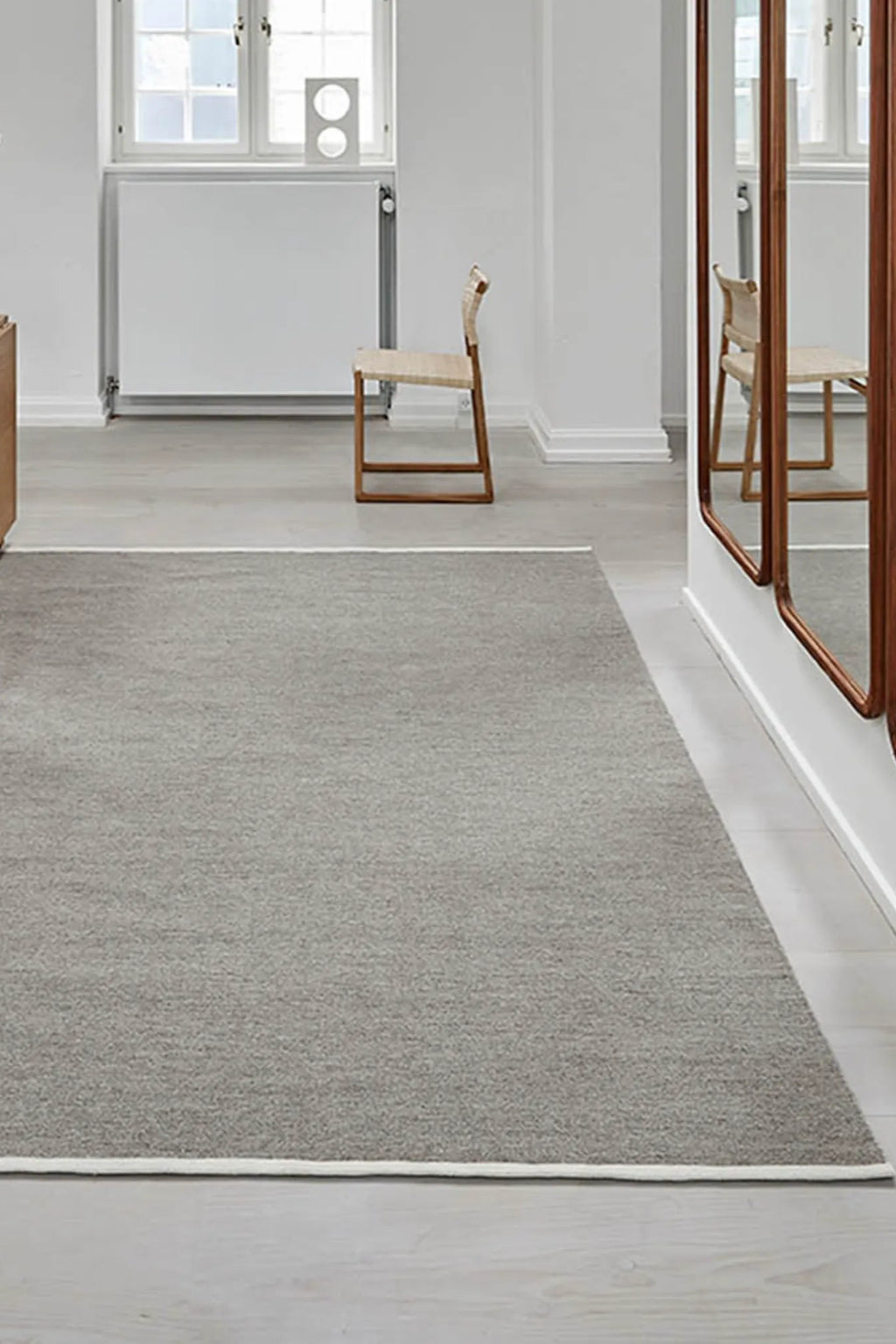 Escape Kelim Rug in warm, earthy tones with intricate border design