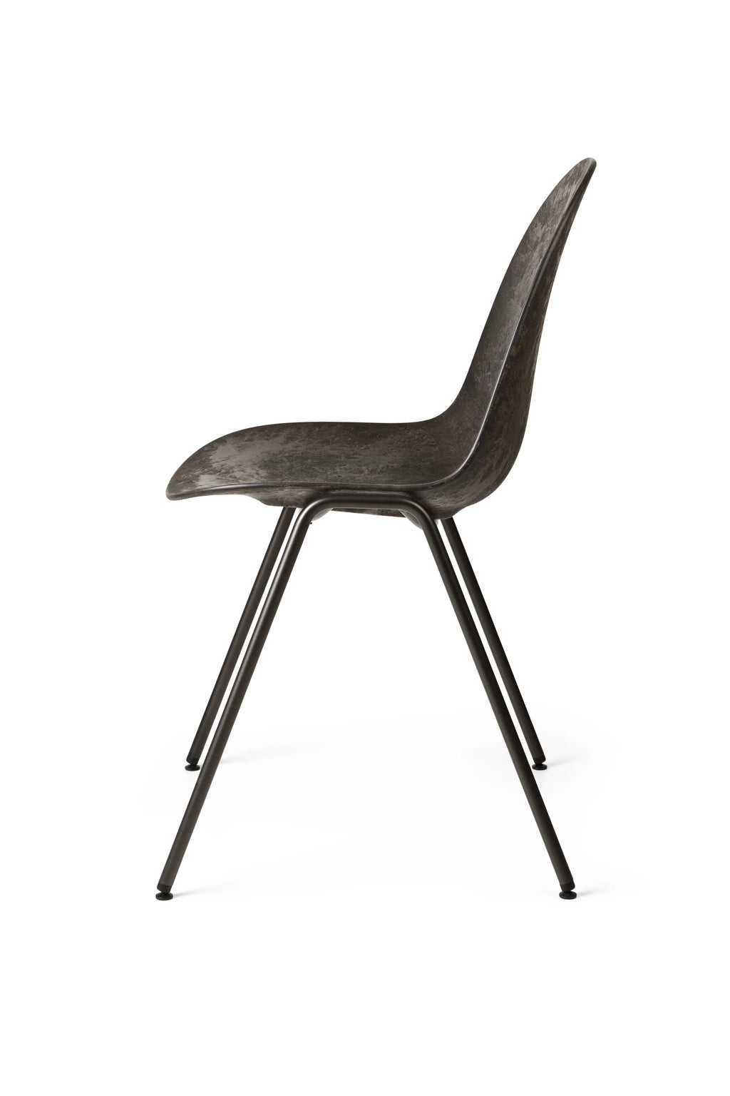 Mater Eternity Sidechair, captured from a side profile, showcasing its sleek, ergonomic silhouette and the seamless integration of the dark textured seat with the black metal frame, on white.