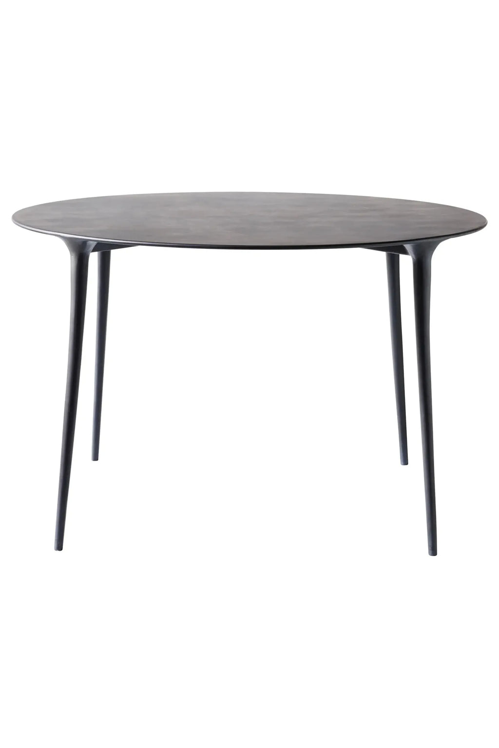 Tine K Feel Metal Round Dining Table, a sleek modern minimalist dining table featuring a smooth matte charcoal metal finish and an elegant round tabletop.
