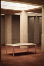 Modern architectural interior with a bench and tall columns.