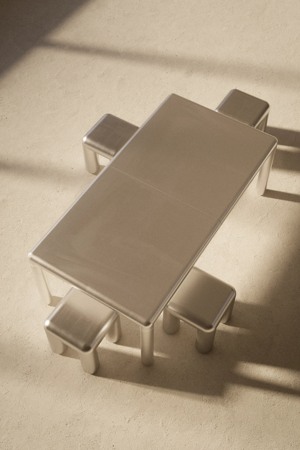 Metallic table and chairs on a textured surface