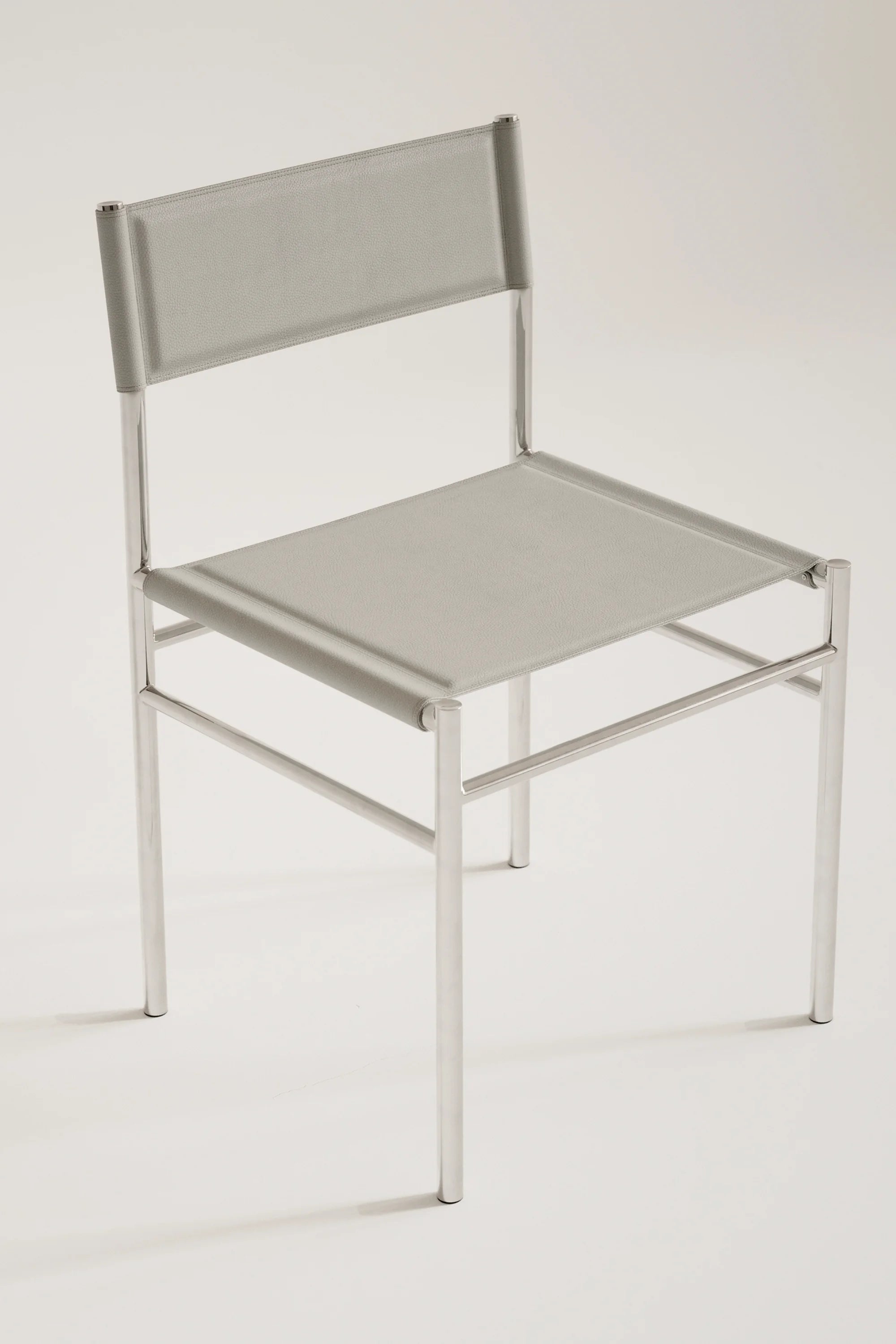 Light gray chair with metal frame on a white background