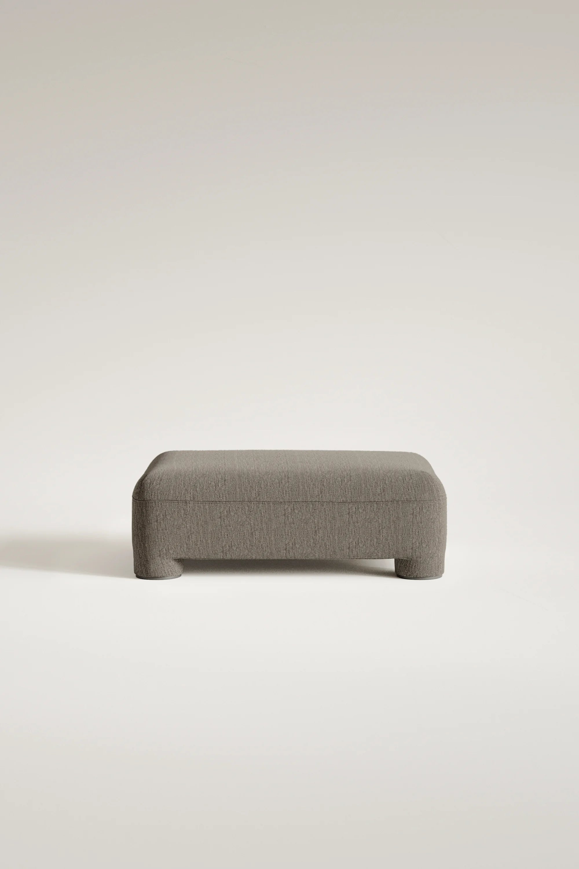 Gray upholstered bench on a light beige background