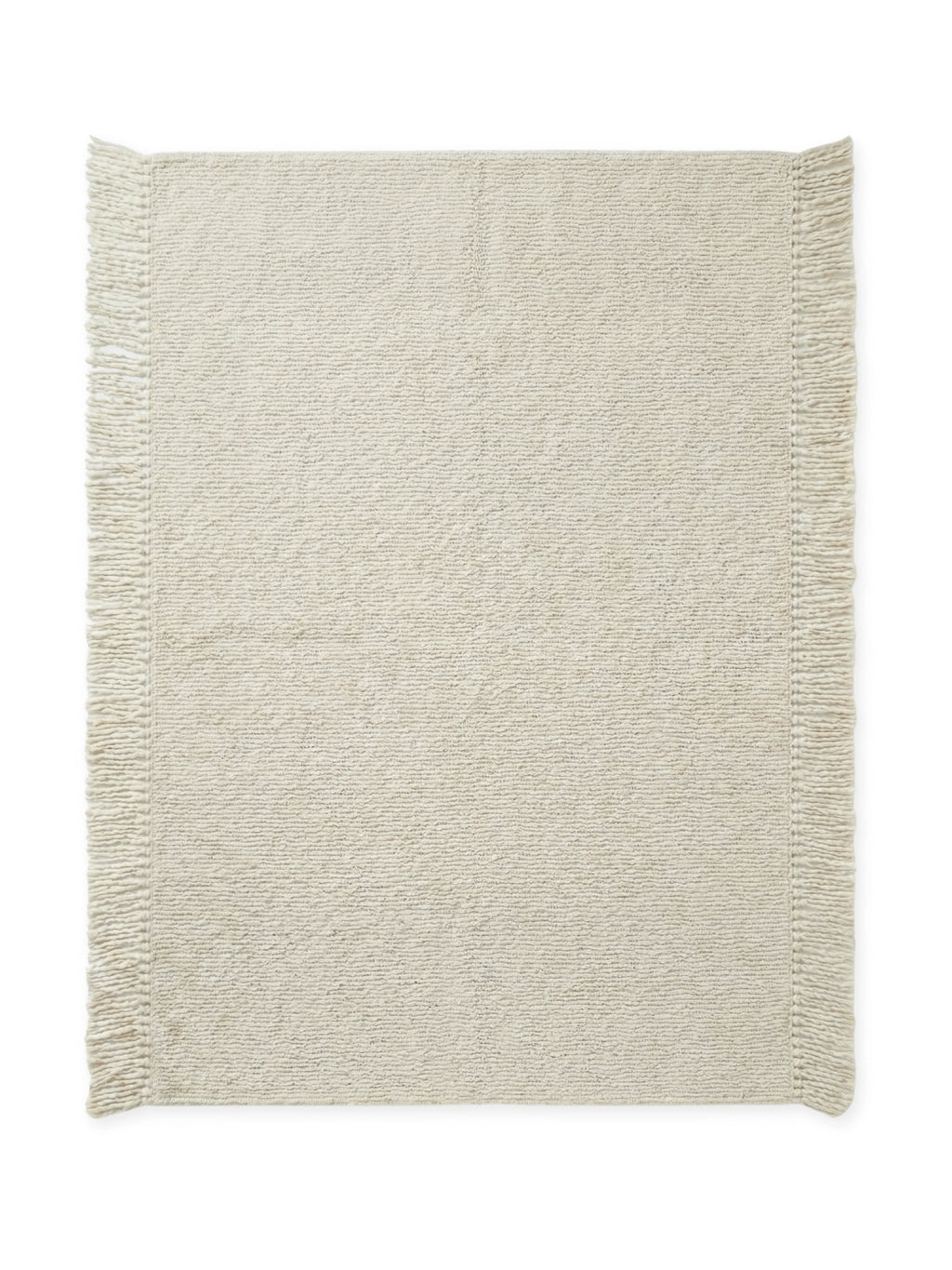 Tinted Objects Fagerlund Wool Rug, a plush, off-white natural wool rug featuring a tightly looped, textured weave and elegant fringed edges. This premium, soft area rug is perfect for adding warmth and a modern, minimalist aesthetic to any living room or bedroom.