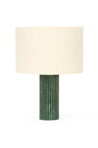 Table lamp with a green textured base and white shade on a white background