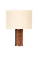 Table lamp with a wooden base and beige fabric shade on a white background