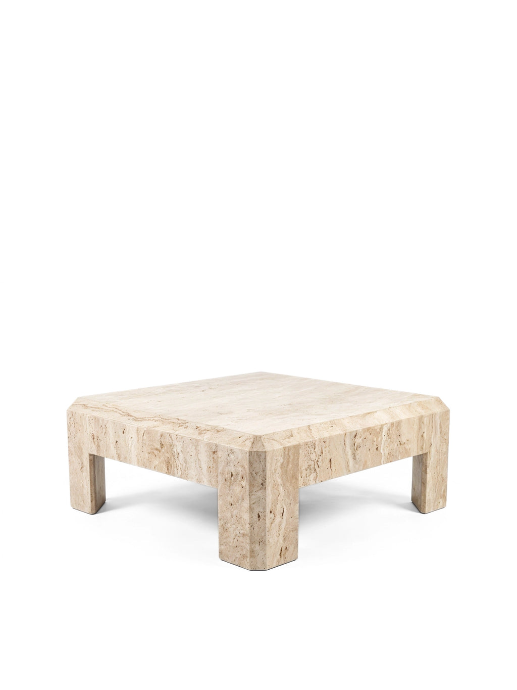 TCL Studios Form Coffee Table, a low-profile square brutalist coffee table crafted from solid natural travertine stone. It features a light beige and cream porous texture with subtle veining, thick block legs, and distinctive chamfered edges on the top and base, embodying a minimalist postmodern aesthetic. This contemporary travertine coffee table is ideal for a modern living room or an organic modern interior seeking a statement piece.