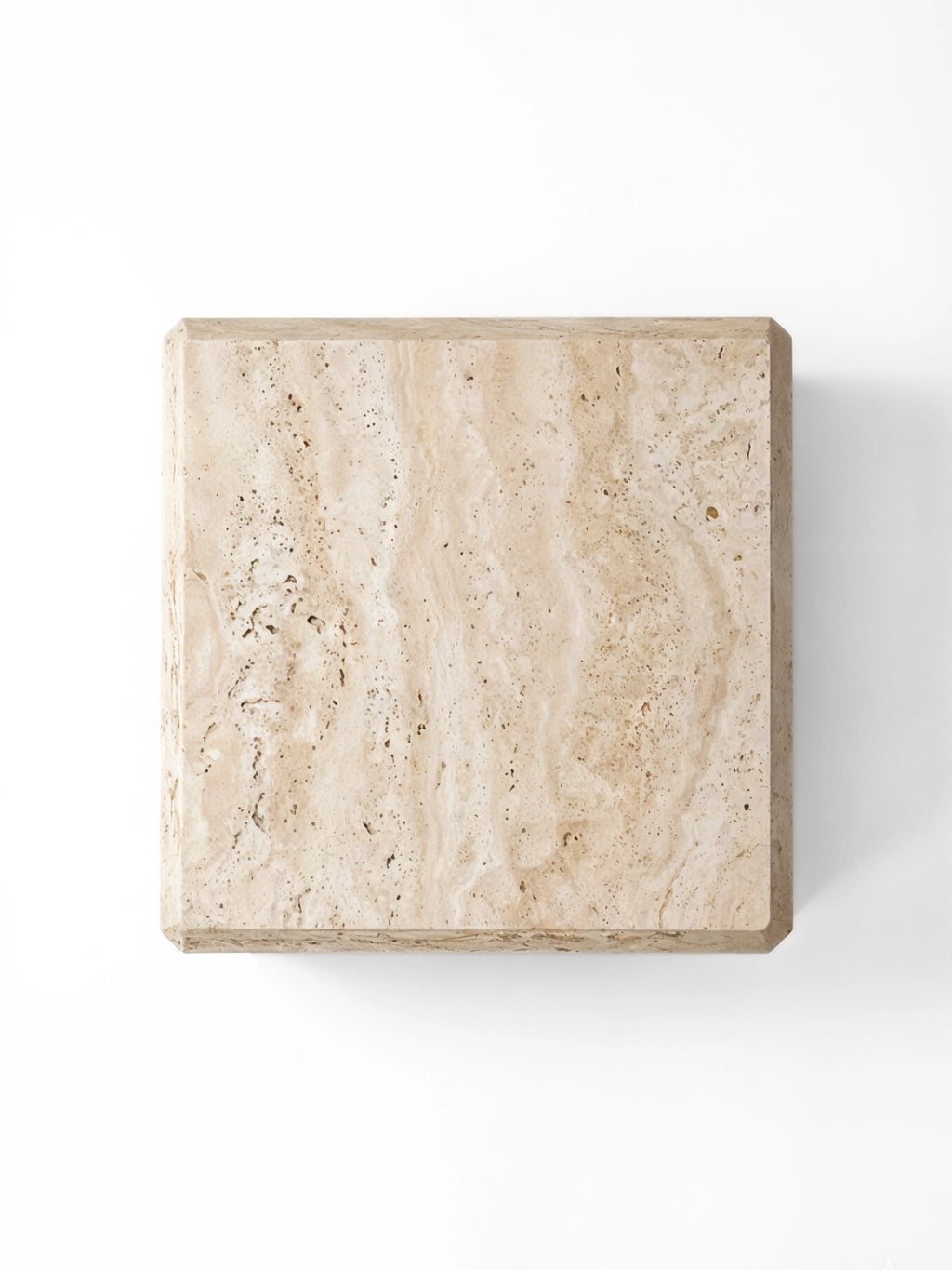 TCL Studios Form Coffee Table, a minimalist square coffee table crafted from solid natural travertine stone with a creamy beige hue, distinctive porous texture, and subtle organic veining.