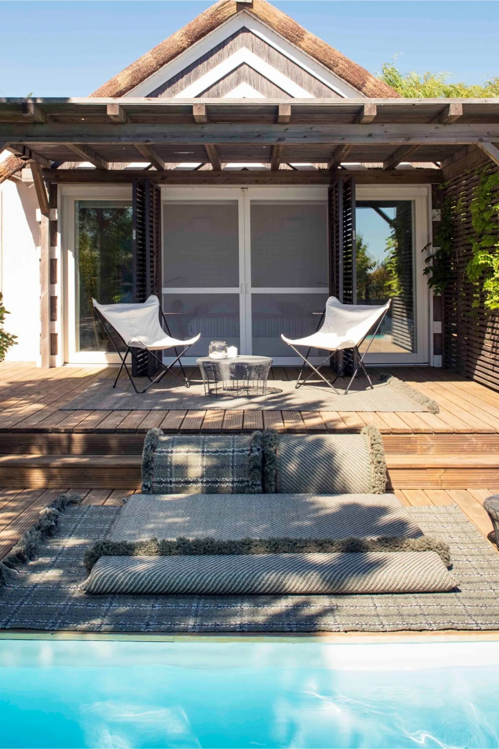 GAN Rugs Garden Layers Composition 04, a modular outdoor sofa featuring grey and cream woven performance fabric cushions with textured herringbone and plaid patterns, accented by olive green fringed edges. This organic modern outdoor lounge system offers comfortable, relaxed poolside seating for contemporary patios and Mediterranean-style decks.