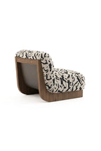 Laskasas Gandhi Lounge Chair, a contemporary lounge chair featuring a distinctive curved dark walnut wood frame that forms a U-shaped base and back support.