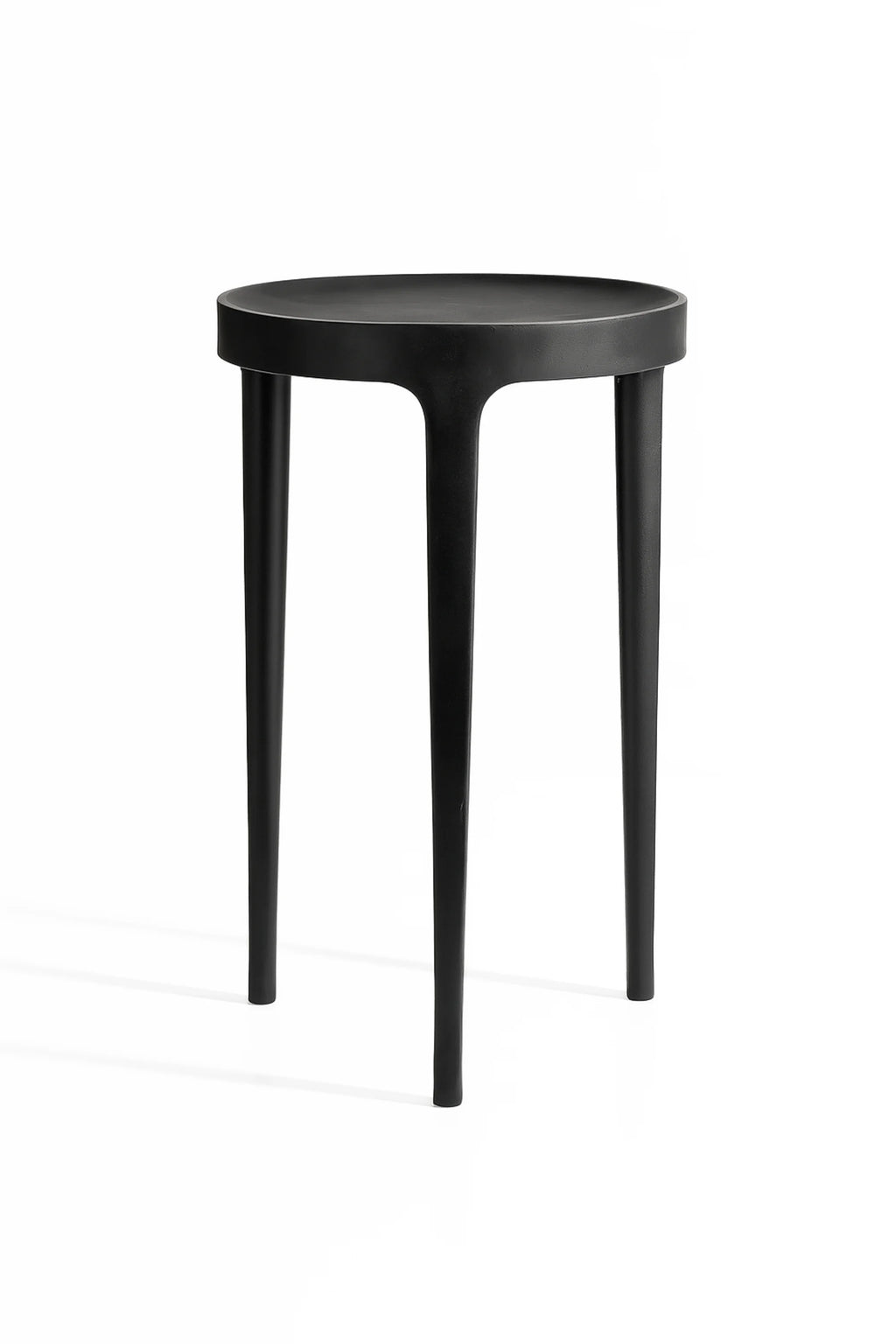 NORR11 Ghost Side Table, a minimalist and elegant round side table in a matte black finish, featuring three subtly tapered legs that blend seamlessly into the tabletop, displayed on a white background.