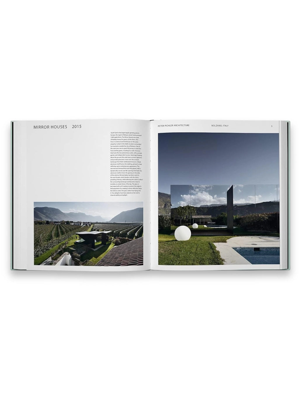 Book Glass Houses, an open architecture hardcover book displaying elegant mirror-clad contemporary homes in a lush, mountainous Italian landscape with sprawling vineyards and a modern pool. This premium architecture book is perfect for design enthusiasts and aspiring architects.