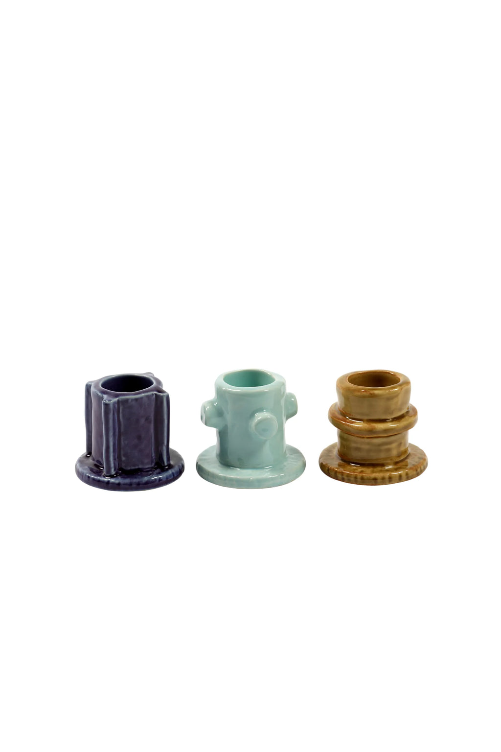 Serax Glazed Molly Candle Holder 01 - Set of 3, featuring unique ceramic candle holders in deep indigo blue, pale aqua, and warm caramel brown, each with a glossy, smooth glaze and distinct architectural shapes. These stylish, modern candle holders are perfect for adding decorative light to any contemporary home or office space.