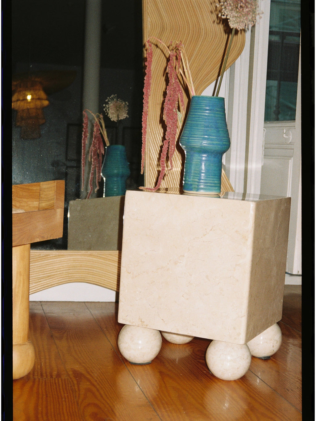 Heaps & Woods Aurelia Side Table, a contemporary organic modern side table crafted from solid light beige travertine stone, featuring a minimalist rectangular cube silhouette with natural veining throughout its polished surface. It stands on four distinctive spherical travertine feet, adding a sculptural element to its brutalist-inspired design, ideal as a luxury accent table for living rooms, bedrooms, or sophisticated entryways.